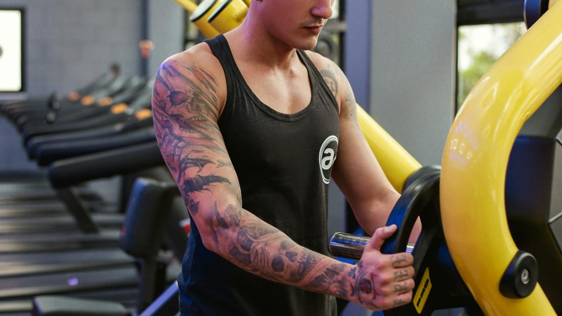 Man performing steady strength training in a modern gym.